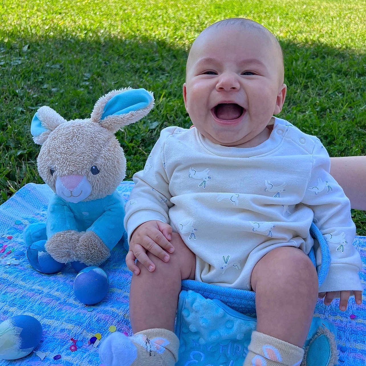 Jaxton is registered to the contest to win money with this photo: baby, clothing, egg, face, food, grass, happy, head, hosiery, nature, outdoors, park, person, photography, plant, portrait, sitting, sock, summer, toy