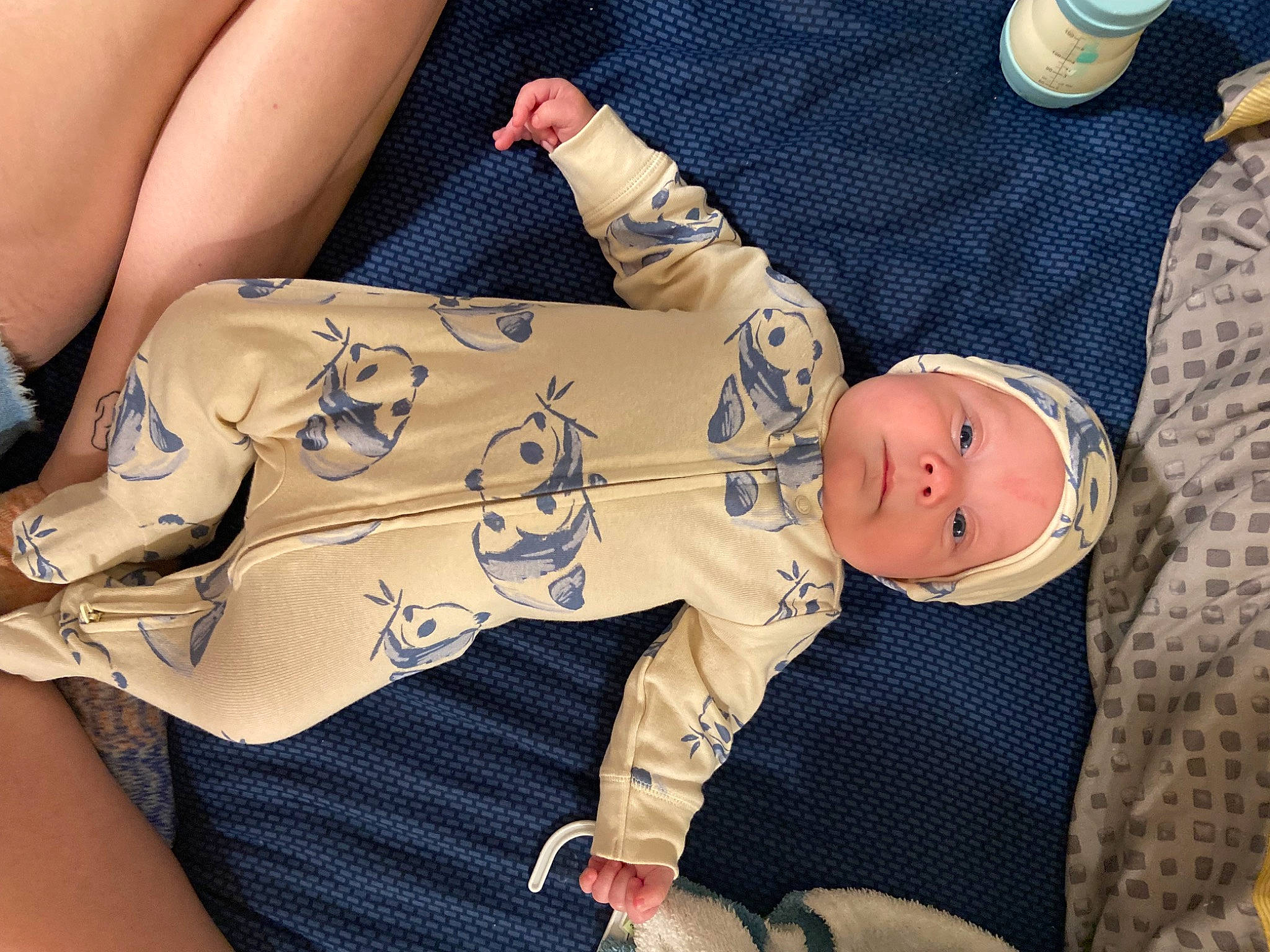 Emerson is registered to the contest to win money with this photo: baby, baby_toddler_clothing, comfort, elbow, finger, gesture, glasses, headwear, human_body, human_leg, joint, knee, leg, pattern, person, skin, sleeve, sunglasses, thigh, toddler