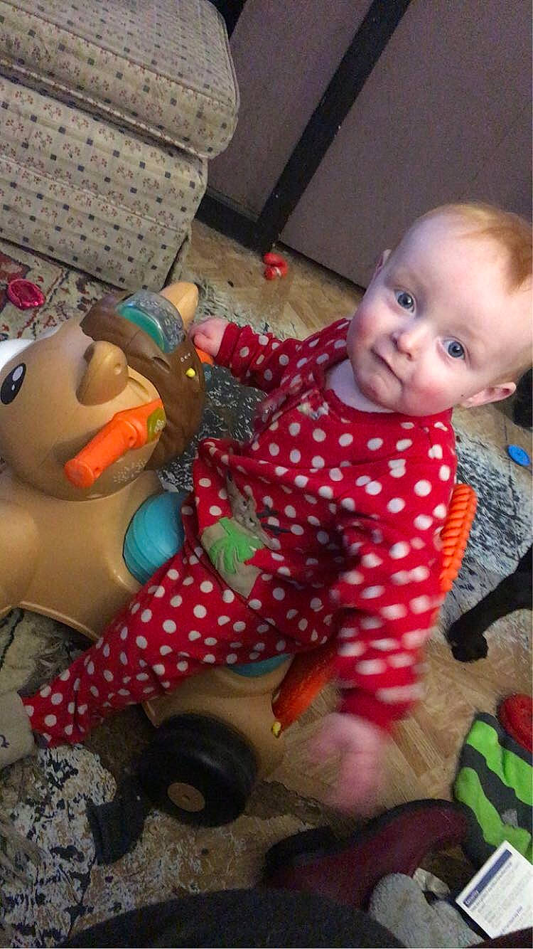 Clint Jr is registered to the contest to win money with this photo: baby, baby_products, baby_toddler_clothing, baby_toys, carmine, child, facial_expression, flooring, fun, happy, lap, pattern, person, play, product, room, sitting, smile, textile, toddler