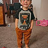 Alakai joined the competition — help win amazing prizes! child, boy, barefoot, carpet, t-shirt, pants, standing, indoors, living_room, toy, curtains, dining_table, smile, hands_in_pockets, home, casual, furniture, clock, wall, happy