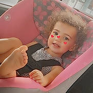 Katalaya is registered to the contest to win money with this photo: toddler, child, car_seat, pink, curly_hair, heart_stickers, striped_clothing, smile, car_interior, window, seatbelt, foot, face, cheeks, cute, young_child, sitting, indoors, safety_harness, vehicle