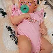 Davontaya joined the competition — help win amazing prizes! baby, infant, pacifier, headband, pink_clothing, blanket, patterned_blanket, lying_down, indoor, cute, child, soft_texture, butterfly_stickers, small_hands, small_feet, adorable, cozy, resting, portrait, infant_girl