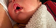 Janël participe au concours pour gagner de l'argent avec cette photo : baby, sleeping, blanket, closeup, face, mouth_open, infant, indoor, cozy, soft_texture, child, resting, cuddle, warm, person, young, peaceful, portrait, newborn, comfort