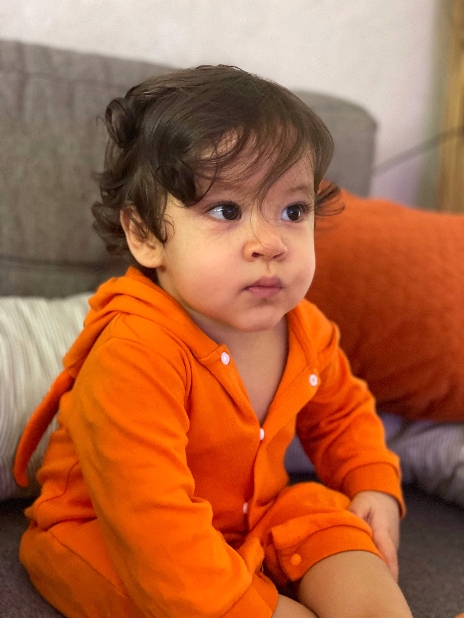 Hayden participe au concours pour gagner de l'argent avec cette photo : arm, baby, baby_toddler_clothing, cheek, chin, comfort, eye, eyebrow, facial_expression, flooring, fun, happy, human_body, iris, lip, nose, orange, person, skin, sleeve