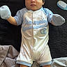 Robert is registered to the contest to win money with this photo: baby, baby_care, baby_wipes, blanket, champion, child, clothing, comfortable, cute, hair_brush, indoors, infant, lying_down, mittens, onesie, person, portrait, socks, soft_surface, young_child