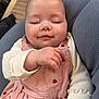 baby, infant, sleeping, peaceful, cheeks, eyelashes, hand, pink_dress, heart_pattern, onesie, close_up, portrait, indoor, sofa, blanket, cushion, soft_fabric, cute, newborn, smile
