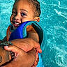 child, toddler, swimming, pool, water, smiling, happy, face, portrait, outdoor, summer, life_vest, adult, arms, safety, splash, red_float, blue_water, wet_hair, recreation