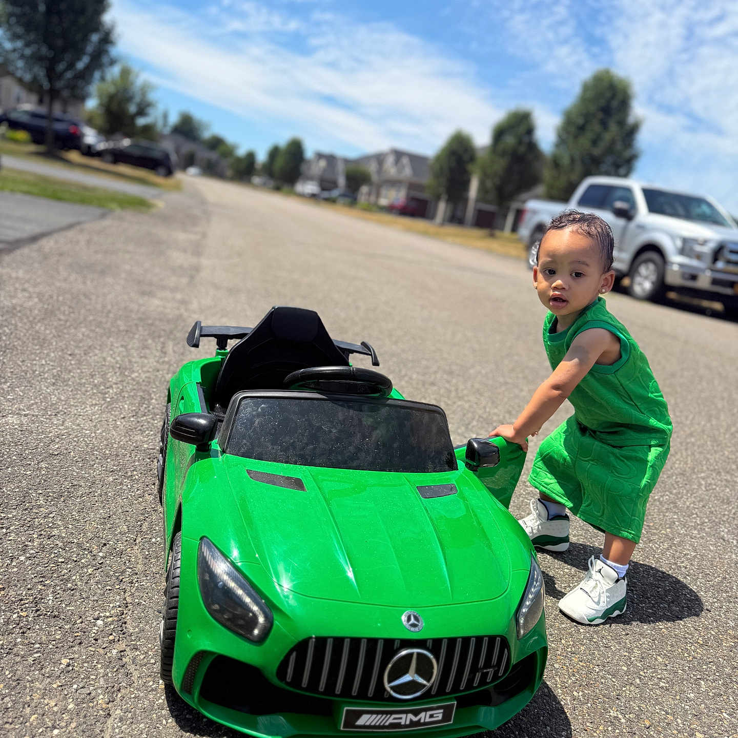 Chosyn joined the competition — help win amazing prizes! car, child, clouds, daytime, green_clothing, kid, outdoor, play, residential_area, road, sidewalk, sky, sneakers, street, summer, sunny, toddler, toy_car, tree, vehicle