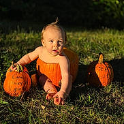Caysen Journey joined the competition — help win amazing prizes! baby, child, infant, pumpkin, halloween, autumn, outdoor, grass, nature, portrait, sitting, barefoot, sunlight, golden_hour, orange, seasonal, harvest, curious, adorable, photography