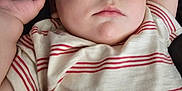 Finnigan is registered to the contest to win money with this photo: arm, baby, blue, child, closeup, clothing, comfort, face, hand, indoors, infant, nap, peaceful, person, pillow, rest, skin, sleeping, soft, striped_shirt