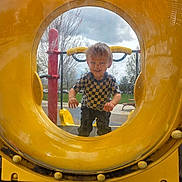Zachary Brooks joined the competition — help win amazing prizes! child, boy, playground, yellow_tunnel, smiling, outdoor, checkered_shirt, play_equipment, grass, trees, cloudy_sky, hands, face, happy, casual_clothing, daylight, park, fun, recreation, young_child