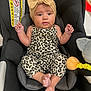 baby, infant, car_seat, leopard_print, headband, bow, clothing, cute, child, person, seat, black, comfort, footwear, indoor, toy, yellow, orange, expression, small