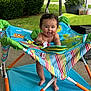 Amiyah joined the competition — help win amazing prizes! baby, child, smiling, outdoor, activity_jumper, colorful, grass, greenery, patio, play, happy, infant, toys, feet, face, person, summer, daylight, clothing, fun