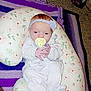 baby, blanket, carpet, clothing, couch, cute, face, floor, flower, hand, headband, indoor, infant, pacifier, pattern, person, pillow, purple, relaxing, white