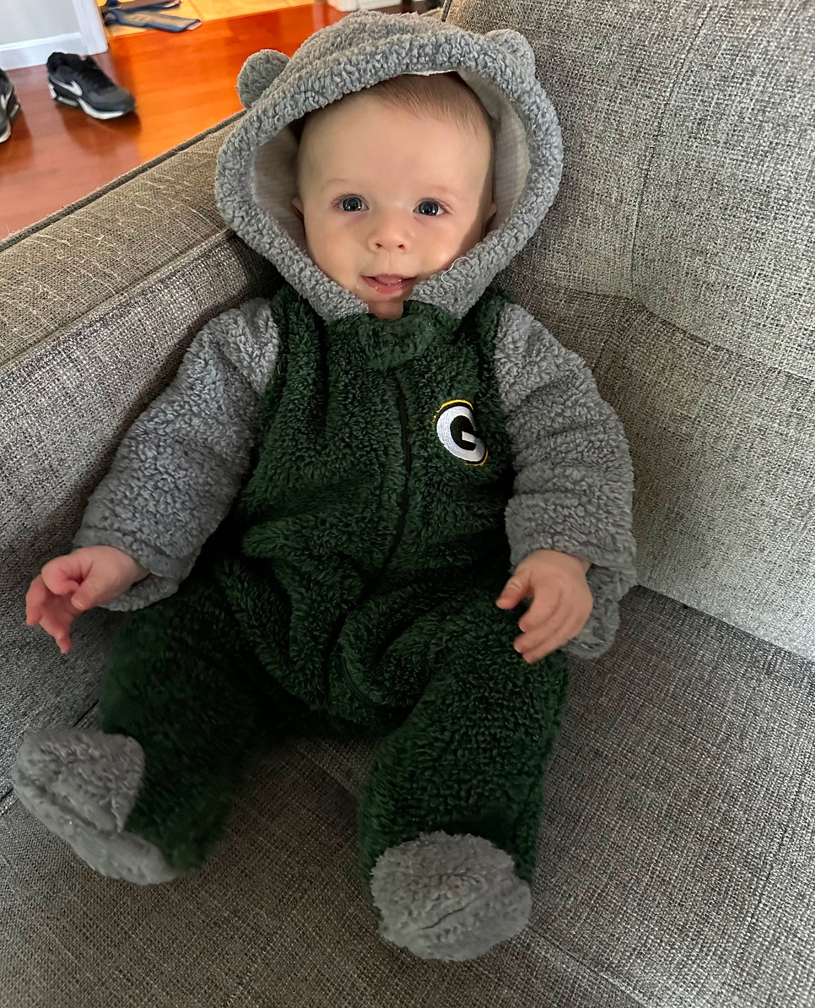 Colter is registered to the contest to win money with this photo: baby, baby_toddler_clothing, cheek, child, comfort, eye, face, flooring, fur, grass, head, human_body, nose, pattern, person, sitting, skin, sleeve, toddler, wood