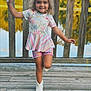 Eliza joined the competition — help win amazing prizes! casual_clothing, child, curly_hair, floral_top, girl, happy, lake, nature, outdoor, playful, portrait, railing, reflection, smiling, striped_skirt, summer, sunset, water, white_boots, wooden_deck