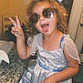 casual, child, countertop, curly_hair, dress, girl, granite, home, indoor, kitchen, light, peace_sign, playful, princess_dress, seat, sign, smiling, sunglasses, tongue_out, wall_decor