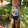 Eliza joined the competition — help win amazing prizes! child, girl, smiling, tree, outdoor, grass, plush_toy, shorts, tank_top, pink_bow, sandals, sunlight, garden, flag, toy, happy, person, summer, nature, playful
