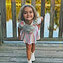 casual_clothing, child, curly_hair, fence, floral_top, girl, happy, innocence, lake, nature, outdoor, person, playful, portrait, smiling, striped_skirt, summer, sunlight, white_boots, wooden_deck