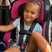 Eliza joined the competition — help win amazing prizes! child, car_seat, smile, braided_hair, seatbelt, car_interior, sunlight, happy, young_girl, sitting, casual_clothing, safety, window, daylight, portrait, seat, vehicle, cute, kid, secure