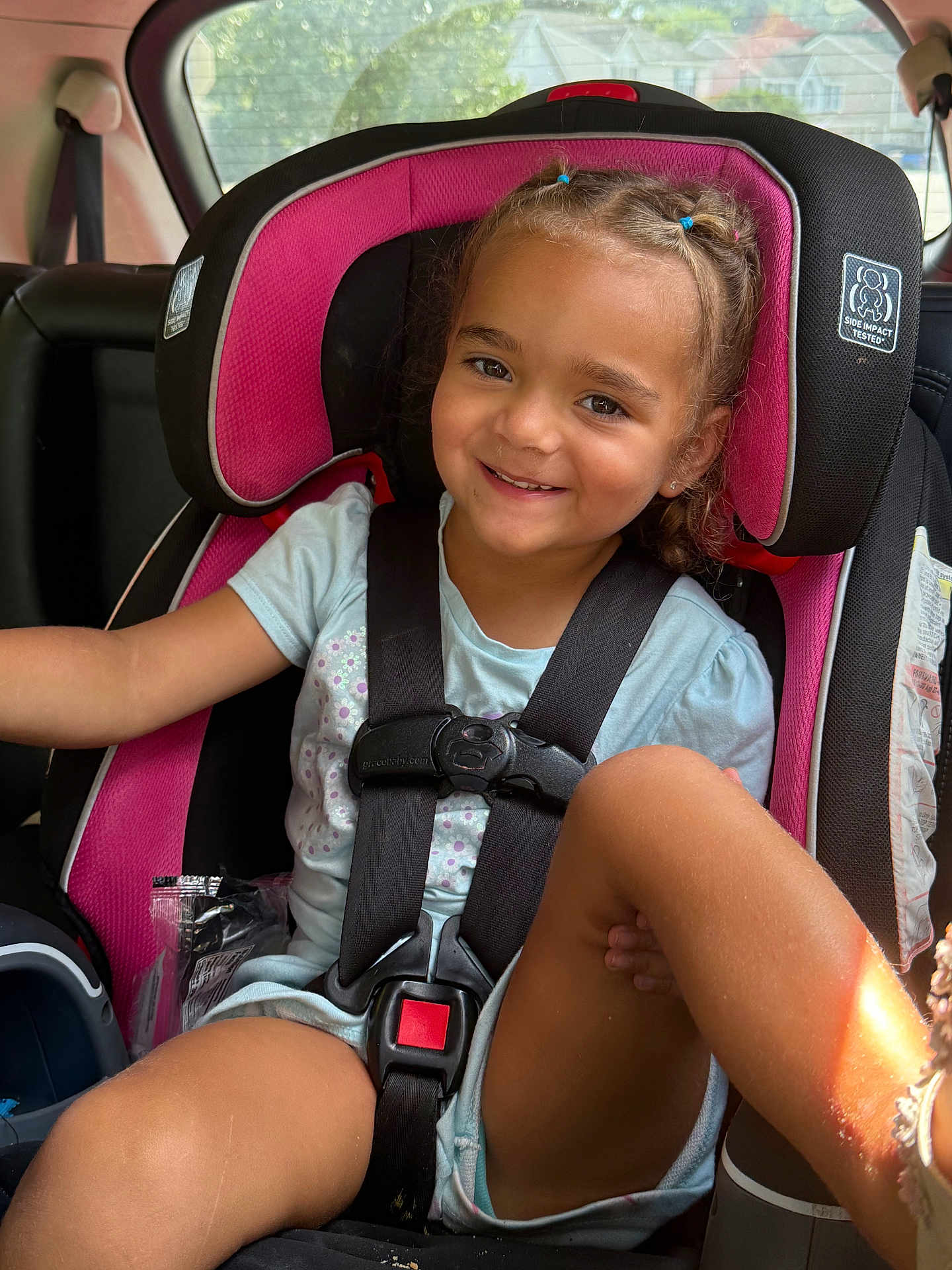 Eliza joined the competition — help win amazing prizes! child, car_seat, smile, braided_hair, seatbelt, car_interior, sunlight, happy, young_girl, sitting, casual_clothing, safety, window, daylight, portrait, seat, vehicle, cute, kid, secure