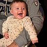 baby, child, adult, person, smiling, laughing, onesie, clothing, gray_hoodie, hand, chair, indoor, happy, cute, face, seated, parent, holding, joyful, expression