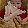 baby, blanket, pacifier, comforter, red_clothing, heart_prints, face, hand, indoor, cozy, soft_texture, infant, child, cute, wrapped, warm, snug, portrait, toddler, resting