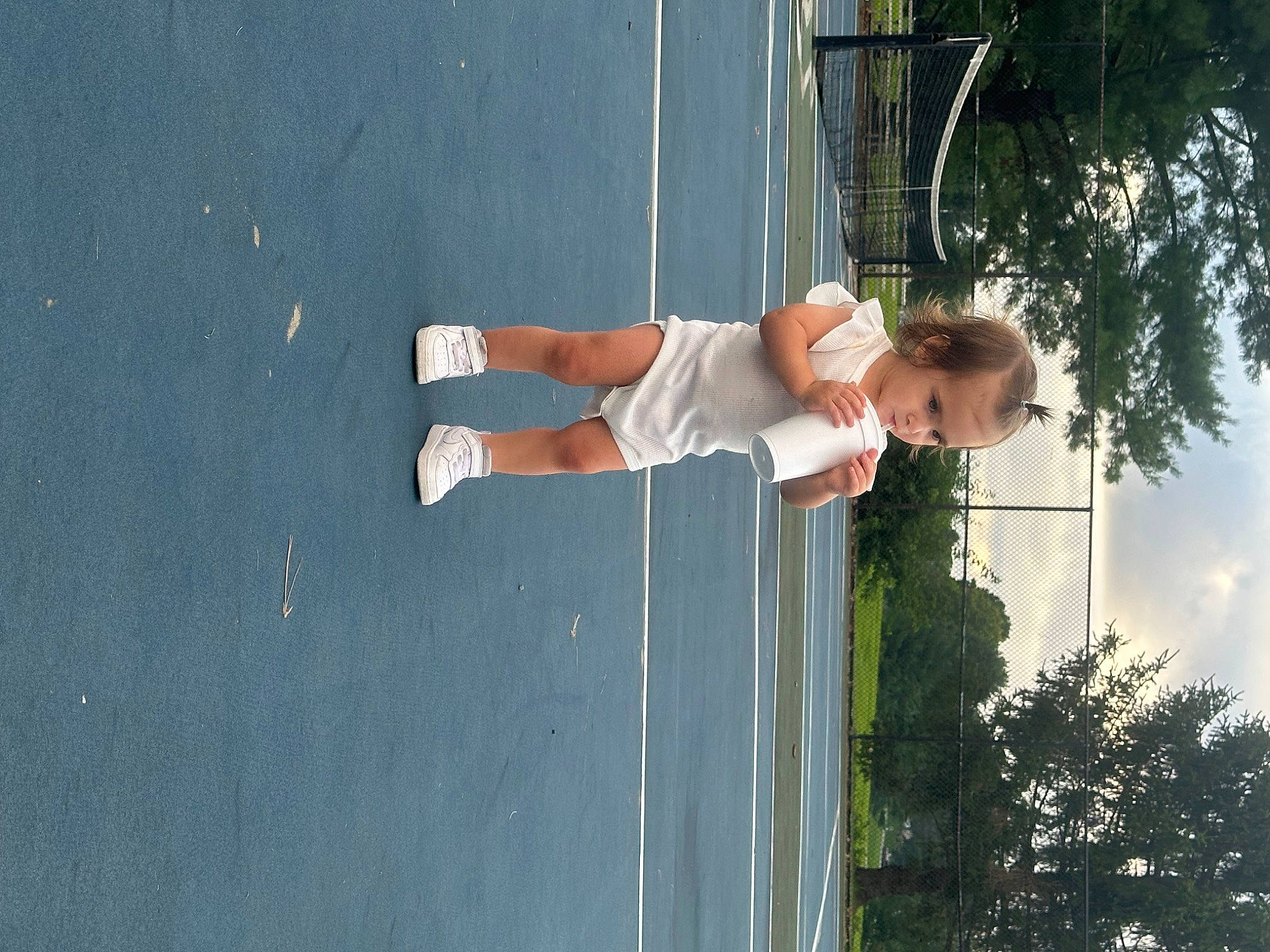 Brinley is registered to the contest to win money with this photo: arm, cloud, elbow, fun, hand, happy, human_leg, knee, leg, leisure, person, plant, recreation, shadow, sky, sports_equipment, thigh, tree, vacation, water