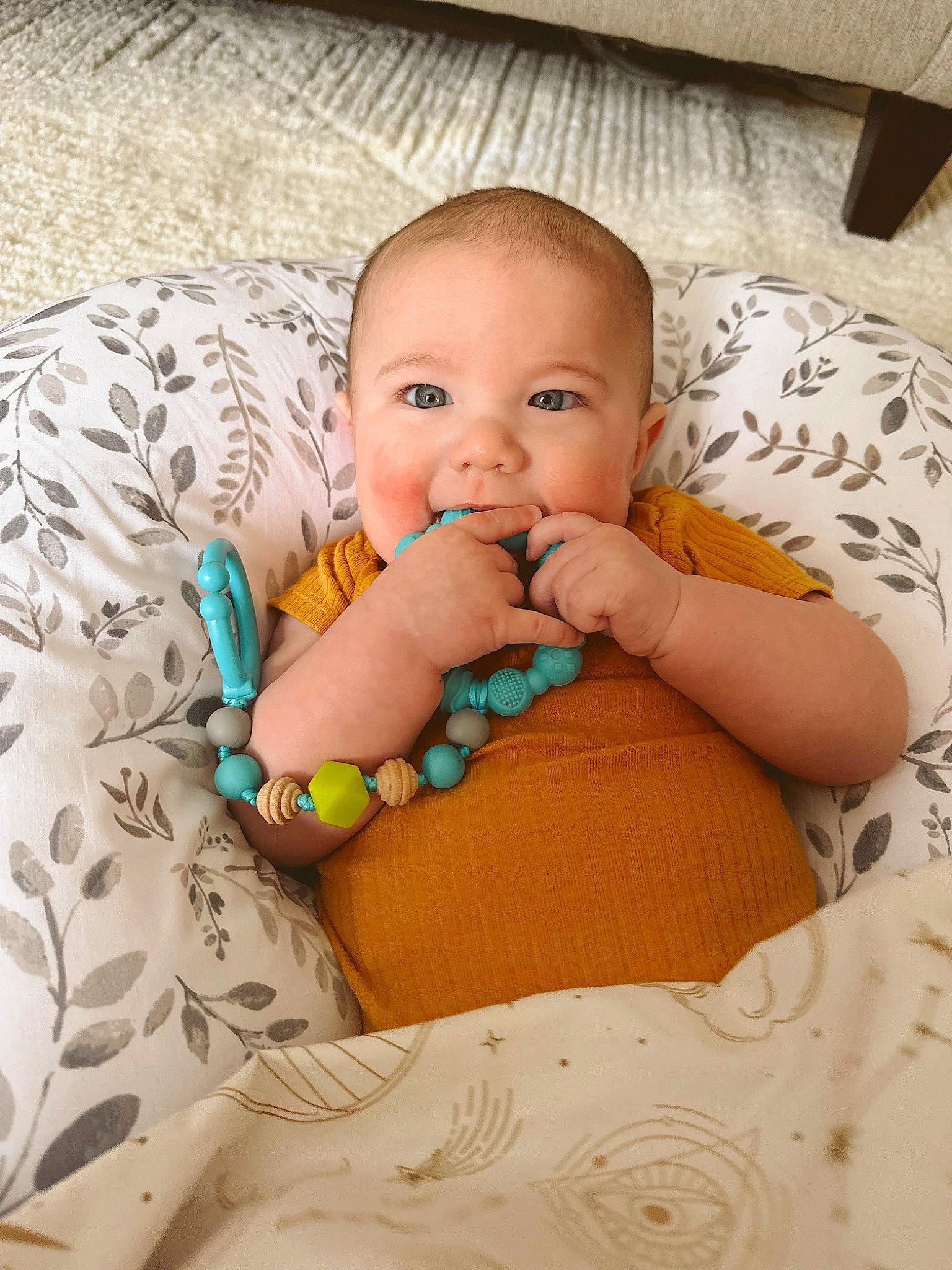 Armani is registered to the contest to win money with this photo: baby, baby_toddler_clothing, cheek, child, comfort, eye, flooring, happy, head, iris, linens, lip, pattern, person, product, sitting, skin, smile, textile, toddler