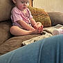 Raelyn is registered to the contest to win money with this photo: barefoot, blanket, bottle, casual, child, clothing, couch, curious, face, furniture, home, indoor, person, pillow, pink_shirt, relaxed, sitting, soft_lighting, toddler, young_child