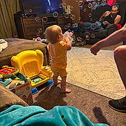 Raelyn joined the competition — help win amazing prizes! adult, barefoot, blanket, bubbles, carpet, child, curtains, engagement, entertainment, family, furniture, home_interior, living_room, man, person, playset, recliner, television, toddler, toy