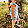 child, girl, smiling, barefoot, tree, outdoor, grass, greenery, nature, summer, casual_clothing, shorts, top, happy, posing, young, moss, leaves, daylight, playful