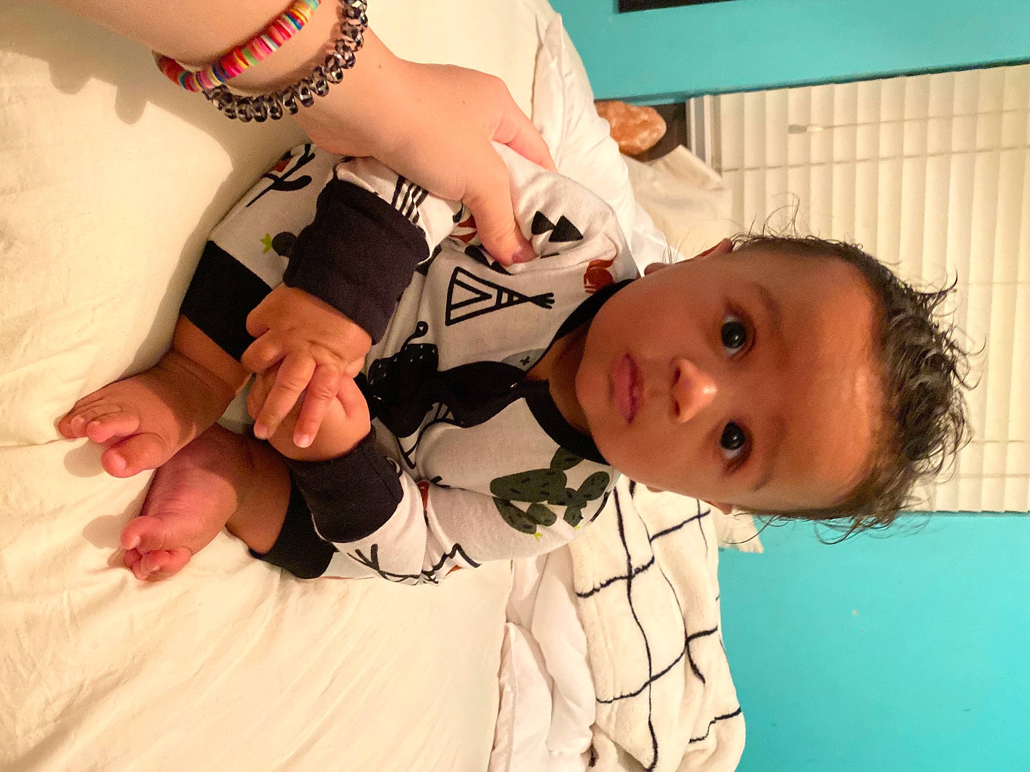 Grayson is registered to the contest to win money with this photo: baby, black_hair, comfort, dress, elbow, eyelash, finger, gesture, hand, happy, human_body, joint, mouth, neck, person, plant, shoulder, skin, sunglasses, thigh