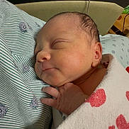 Alayah joined the competition — help win amazing prizes! newborn, baby, sleeping, blanket, hand, face, infant, cozy, patterned_fabric, closeup, resting, peaceful, soft_lighting, indoor, cute, tiny, portrait, wrapped, bed, comfort