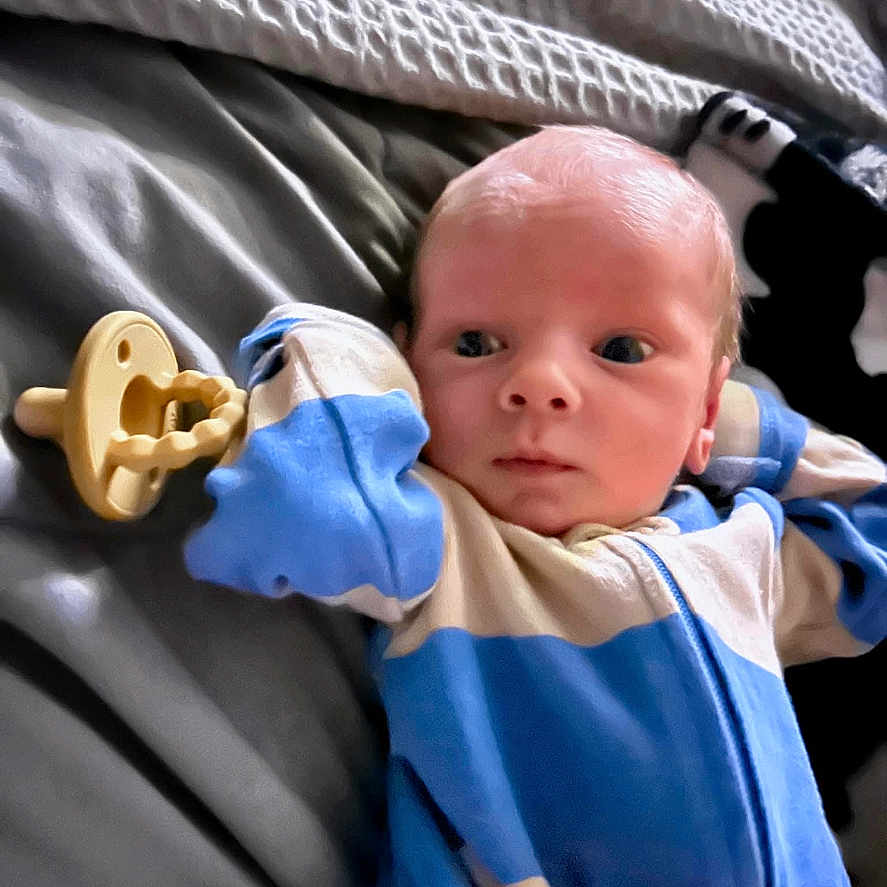 Greyson is registered to the contest to win money with this photo: architecture, baby, bed, blanket, bodypart, building, clothing, cushion, face, finger, furniture, glove, hand, head, homedecor, hospital, newborn, person, photography, portrait