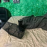 black_kitten, blanket, bed, green_wall, poster, chair, mesh_wastebasket, curious, indoor, furniture, messy_bed, pet, animal, small_cat, resting, cozy, domestic, room, fabric, texture