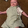 Julian is registered to the contest to win money with this photo: baby, infant, carpet, toy, xylophone, romper, striped_clothing, wooden_buttons, drool, lying_down, curious, child, indoor, floor, playtime, cute, person, casual_clothing, small_toy, relaxed