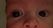 Julian is registered to the contest to win money with this photo: baby, close_up, face, eyes, infant, looking, portrait, skin, expression, indoor, head, child, young, curious, pacifier, light, shadow, background, person, cute