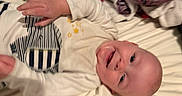 Julian joined the competition — help win amazing prizes! baby, smiling, infant, bed, clothing, white_outfit, stars, stripes, drool, happy, lying_down, blanket, fabric, child, cute, face, person, indoors, toddler, sleepwear