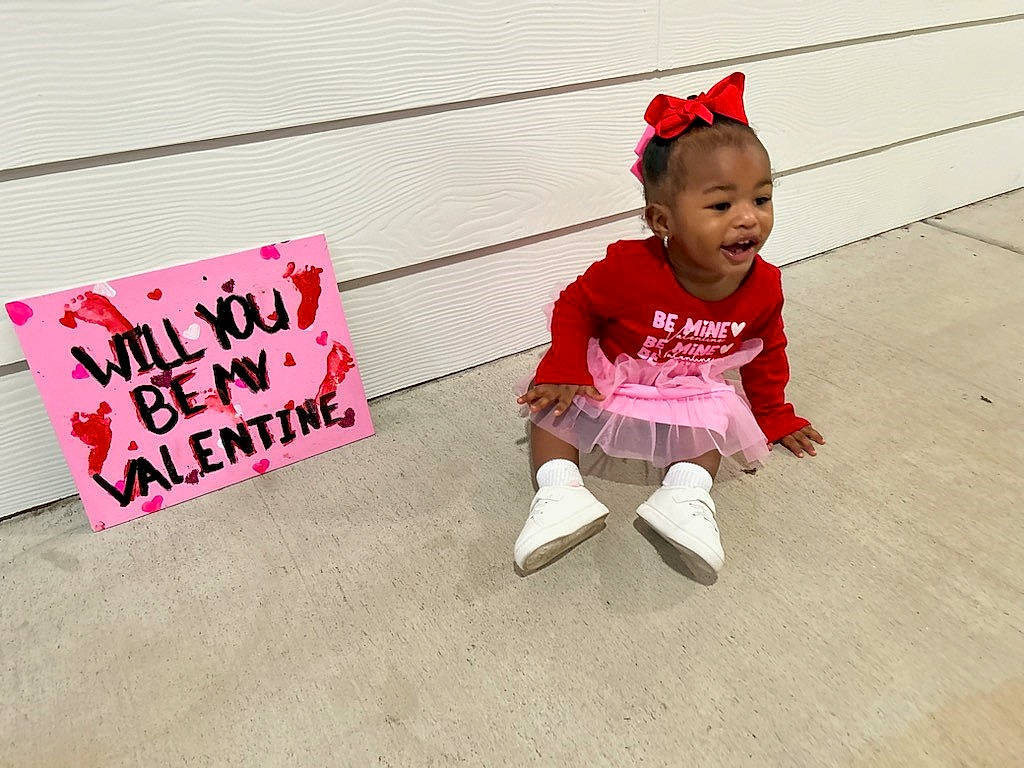 Taylyn joined the competition — help win amazing prizes! baby, baby_toddler_clothing, carmine, child, costume_hat, event, flooring, font, fun, happy, magenta, person, pink, rectangle, sitting, sleeve, smile, t_shirt, toddler