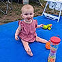 baby, child, outdoor, blue_blanket, pink_dress, toy, high_chair, grass, tent, car, smiling, sitting, playful, happy, daylight, barefoot, grass_patch, plastic_toy, camping, family