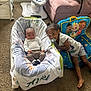 Sayora is registered to the contest to win money with this photo: baby, child, infant, girl, blanket, pacifier, carpet, chair, baby_seat, toy, indoor, smile, person, furniture, clothing, car_seat, cute, family, home, carpeted_floor