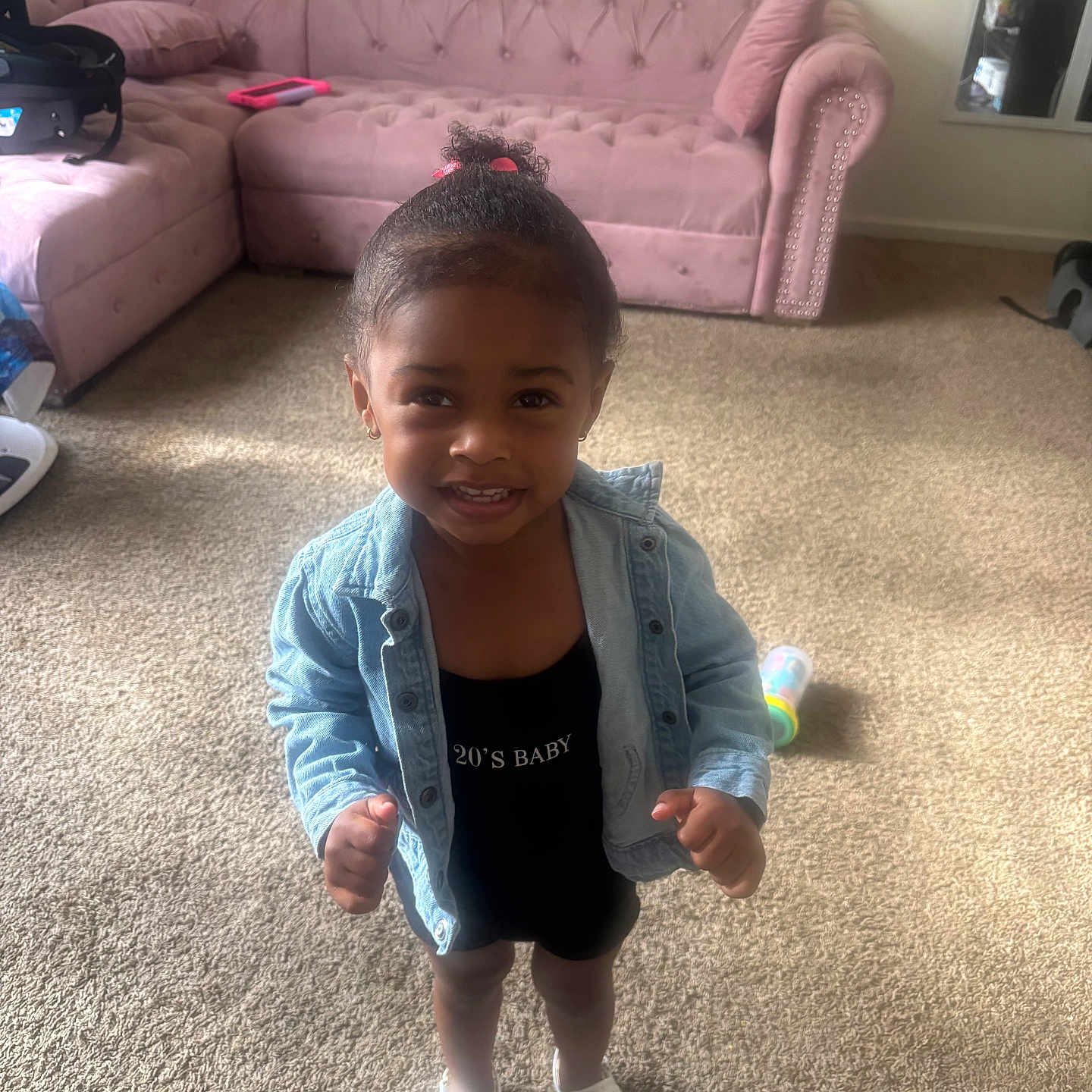 Sayora joined the competition — help win amazing prizes! black_outfit, carpet, child, cute, denim_jacket, earrings, hair_tie, happy, home, indoor, living_room, person, pillow, pink_toenails, sandals, small_child, smiling, sofa, toddler, toy