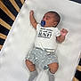 baby, sleeping, pacifier, onesie, crib, wooden_bars, gray_shorts, socks, infant, peaceful, indoor, child, cute, resting, clothing, person, toddler, bed, white_mattress, young_child