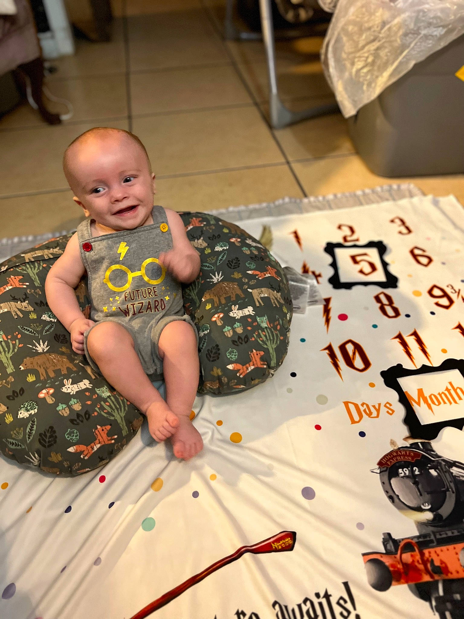 Nash is registered to the contest to win money with this photo: art, artist, baby, chair, child, event, flooring, font, fun, happy, indoor_games_and_sports, joy, leisure, pattern, person, play, sitting, smile, toddler, tradition