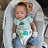 Ocean joined the competition — help win amazing prizes! baby, infant, smile, baby_bouncer, clothing, mittens, socks, pants, shirt, face, hair, indoor, carpet, toy, monkey_print, rainbow, sun, turtle_print, seat, cute