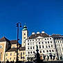Tchika a rejoint le concours — aidez-le/la à gagner de superbes lots ! building, city, classical_architecture, downtown, facade, flag, house, medieval_architecture, metropolis, mixed_use, pole, sky, spire, street, street_light, tourism, town_square, travel, turret, window