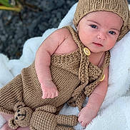 Ethan Ramos joined the competition — help win amazing prizes! baby, infant, knitted_clothing, hat, teddy_bear, blanket, soft_texture, cute, portrait, outdoor, child, cozy, hand, face, eyes, skin, relaxed, lying_down, warm, plush_toy