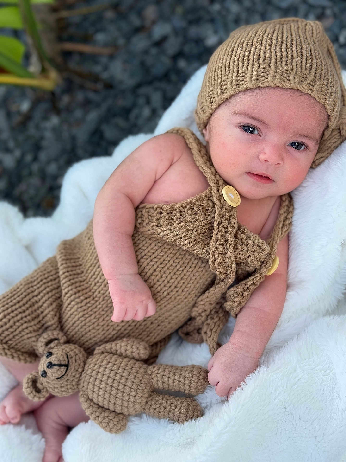 Ethan Ramos joined the competition — help win amazing prizes! baby, infant, knitted_clothing, hat, teddy_bear, blanket, soft_texture, cute, portrait, outdoor, child, cozy, hand, face, eyes, skin, relaxed, lying_down, warm, plush_toy