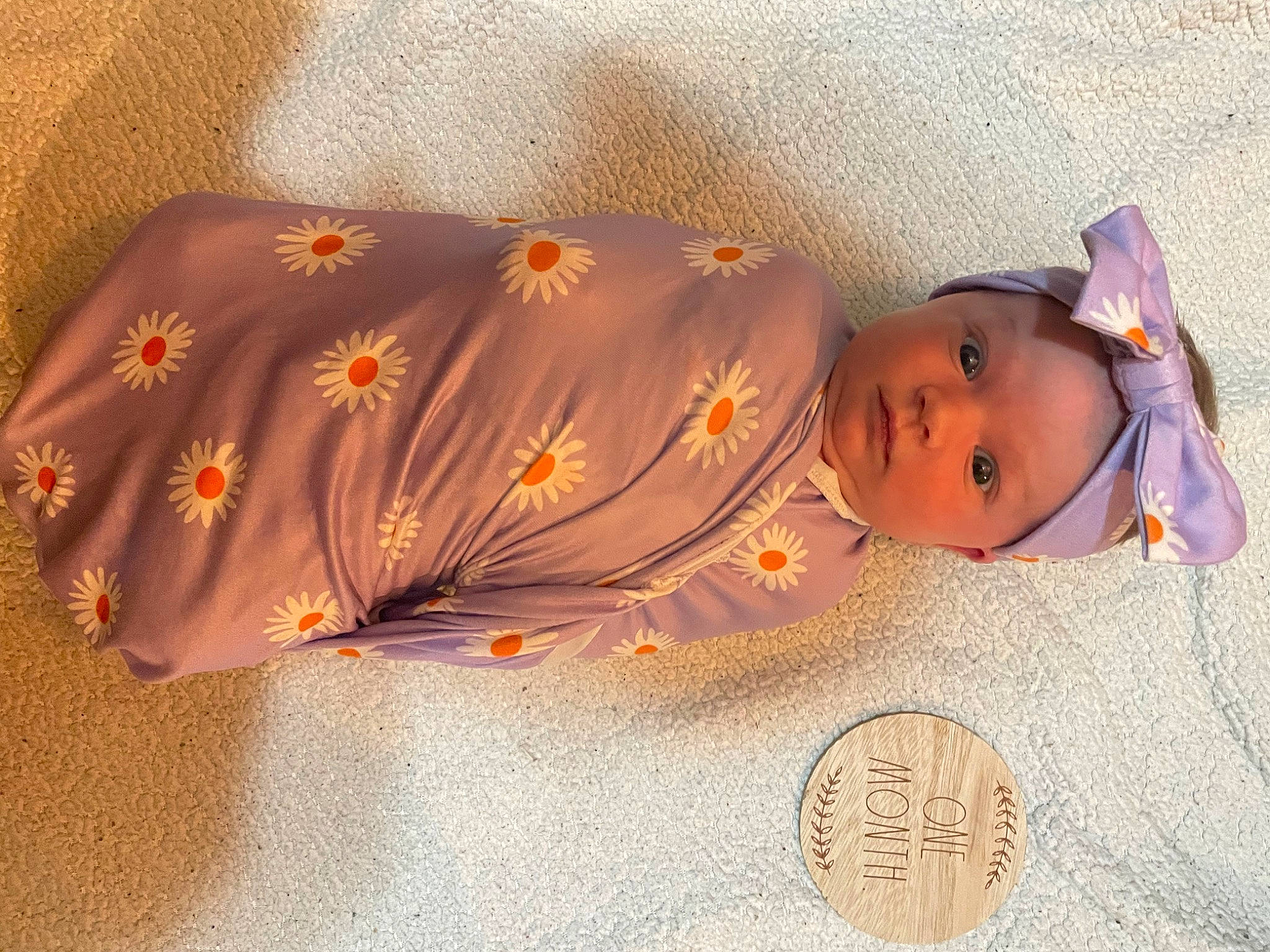Ellie is registered to the contest to win money with this photo: baby, baby_products, baby_toddler_clothing, child, circle, comfort, day_dress, fashion_accessory, flower, linens, pattern, peach, person, petal, silk, sleeve, textile, toddler
